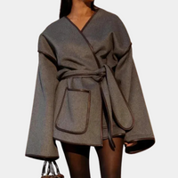 Frau in grauem Wollmantel mit Gürtel und Taschen, modisch, elegant, Herbstmode.