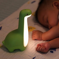 Grüne Dinosaurier-Nachtlampe aus Silikon mit LED, ideal für Babyzimmerbeleuchtung.