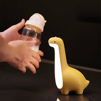 Gelbe Dinosaurier-Nachtlampe aus Silikon mit LED-Licht, ideal für Kinderzimmer.