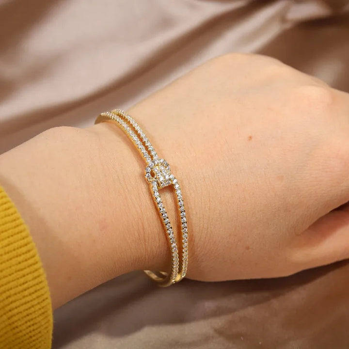 Goldenes Armband mit Diamanten auf Hand, eleganter Schmuck, luxuriöses Accessoire, Damenmode.