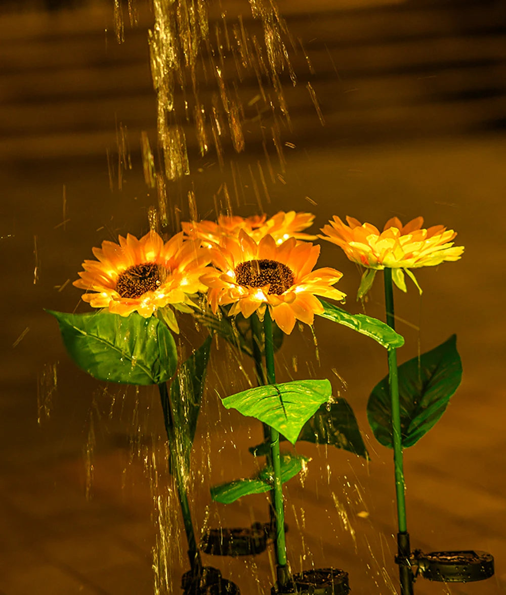 Künstliche Sonnenblumen mit Wasserstrahl, gelb, Dekoration, Nachtaufnahme.