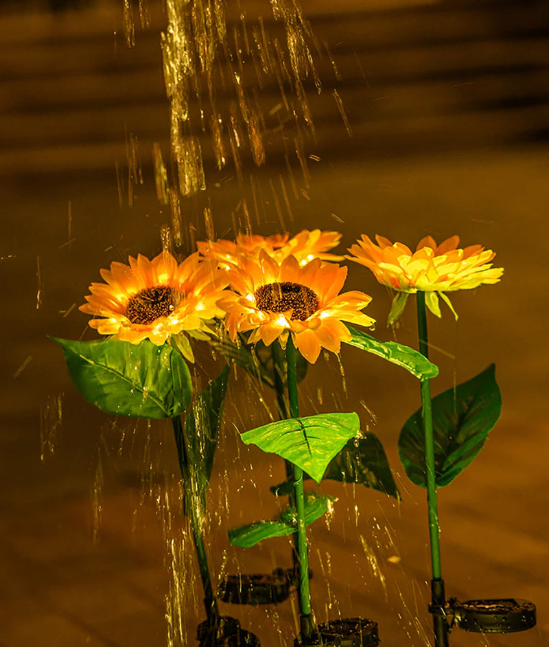 Künstliche Sonnenblumen mit Wasserstrahl, gelb, Dekoration, Nachtaufnahme.