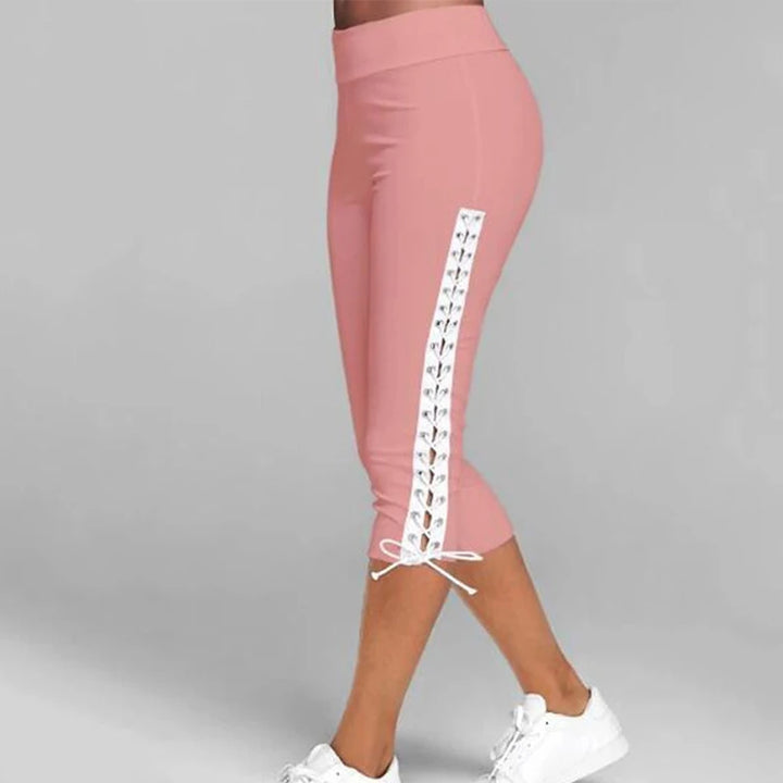 Damen rosa Leggings mit weißer Schnürung, knielang, sportlich, bequem, modisch.