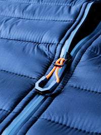 Dunkelblaue Steppjacke mit Reißverschluss, orange Kordel, Wintermode, isoliert, wasserabweisend.