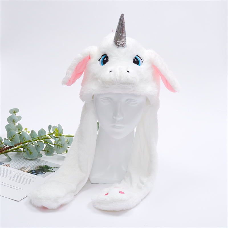Weiße Einhorn-Mütze mit Plüsch, rosa Ohren und silbernem Horn, ideal für Kinder.