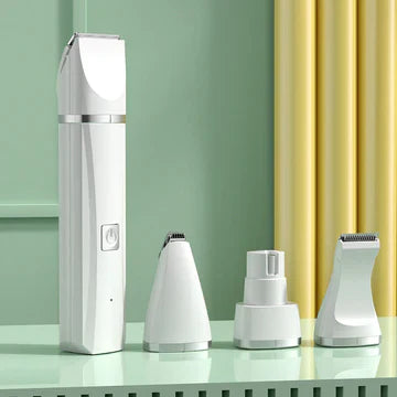 Weißer elektrischer Haarschneider mit drei Aufsätzen auf grünem Hintergrund.