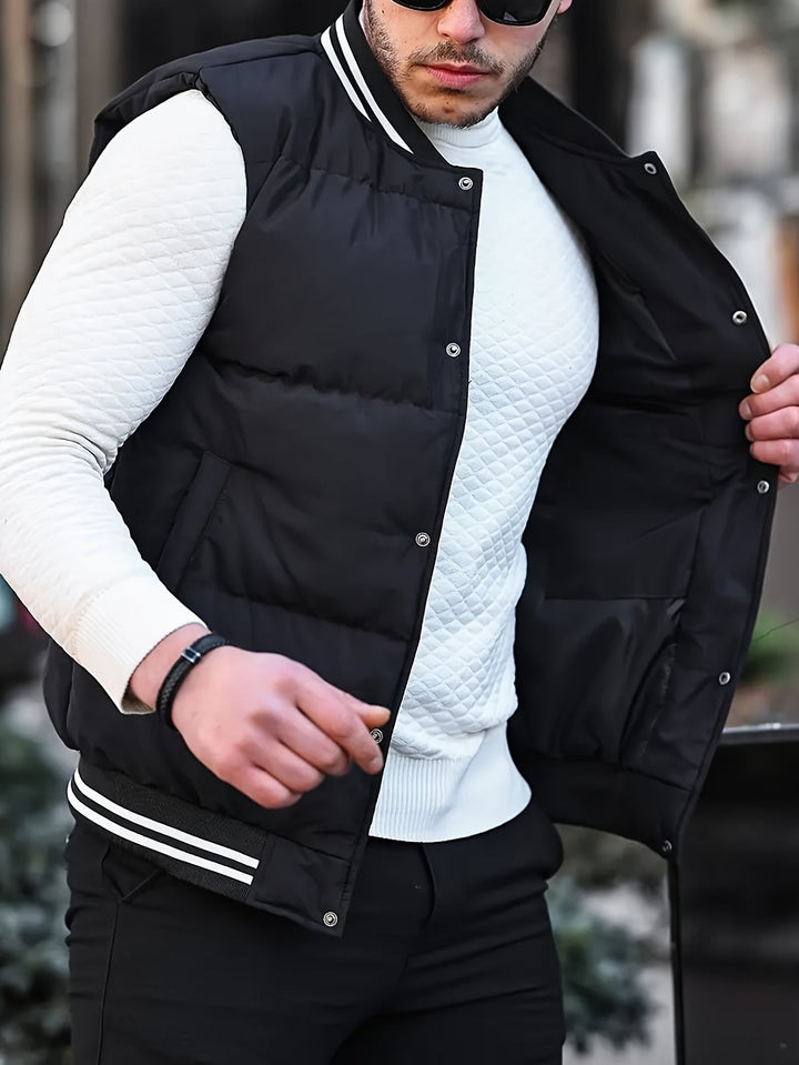 Mann in schwarzer Steppweste und weißem Pullover, modisch, urbaner Stil, Herrenmode.