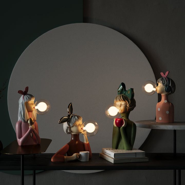 Vier bunte, moderne Tischlampen in Form von Figuren mit Glühbirnen als Kaugummiblasen.