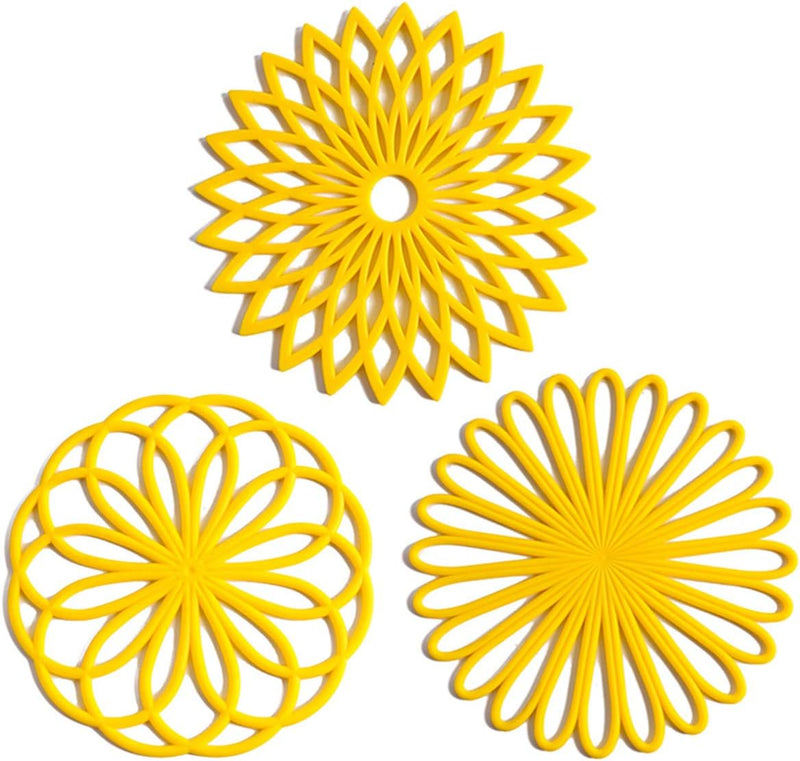 Drei gelbe Silikon-Untersetzer, hitzebeständig, rutschfest, dekoratives Küchendesign.