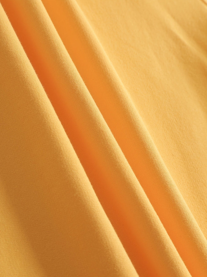 Gelber Baumwollstoff, weiche Textur, ideal für Kleidung, Nähprojekte, hochwertige Stoffe.