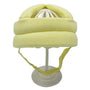Gelber Baby-Schutzhelm aus Baumwolle auf weißem Ständer, ideal für Kleinkind-Sicherheit.