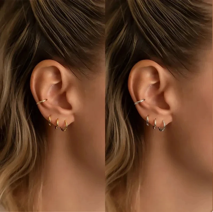 Frau mit goldenen und silbernen Creolen, Ohrschmuck, modische Ohrringe, Schmucktrends.