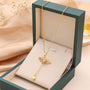 Goldene Halskette mit Herzanhänger und rosa Kristall in Geschenkbox, eleganter Schmuck.