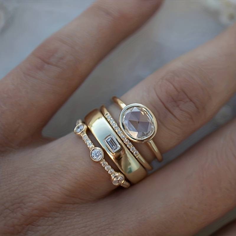 Goldene Ringe mit Diamanten auf Finger, eleganter Schmuck, luxuriöses Design, Nahaufnahme.