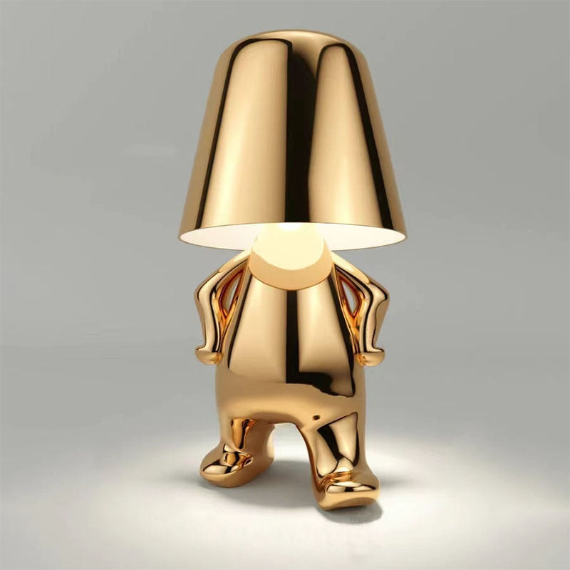 Goldene Tischlampe in menschlicher Form, modernes Design, glänzend, dekorative Beleuchtung.
