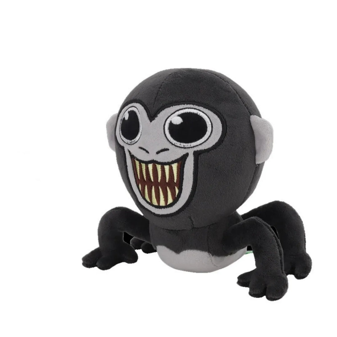 Schwarzes Gorilla-Tag-Plüschtier mit großen Augen und breitem Lächeln, weiches Kuscheltier.