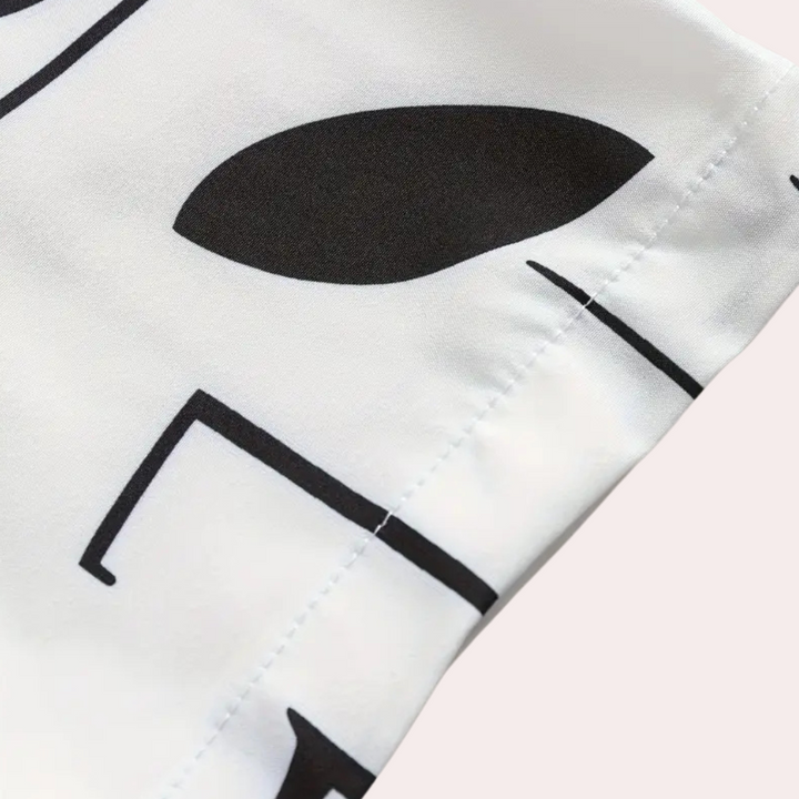 Schwarz-weißes geometrisches Muster auf Stoff, Nahaufnahme, modernes Design, Textilmaterial.