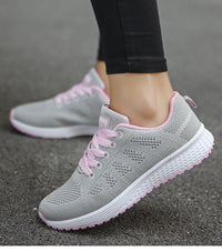Graue Damen-Sneaker mit rosa Schnürsenkeln, atmungsaktiv, ideal für Laufen und Freizeit.