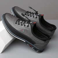 Graue Herrenschuhe aus Leder mit Schnürsenkeln, sportlich-elegant, rutschfeste Sohle.