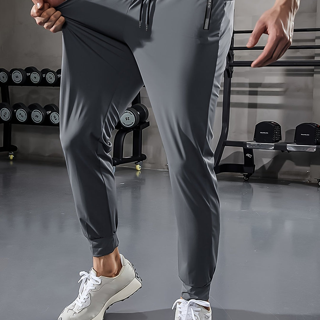 Graue Jogginghose Herren, Sportbekleidung, Fitnessstudio, elastisch, bequem, modern, atmungsaktiv.