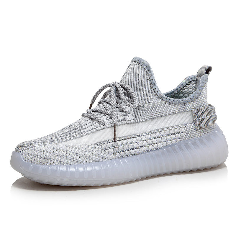 Grauer Sneaker aus Strickmaterial, sportlich, modisch, mit Schnürsenkeln und transparenter Sohle.