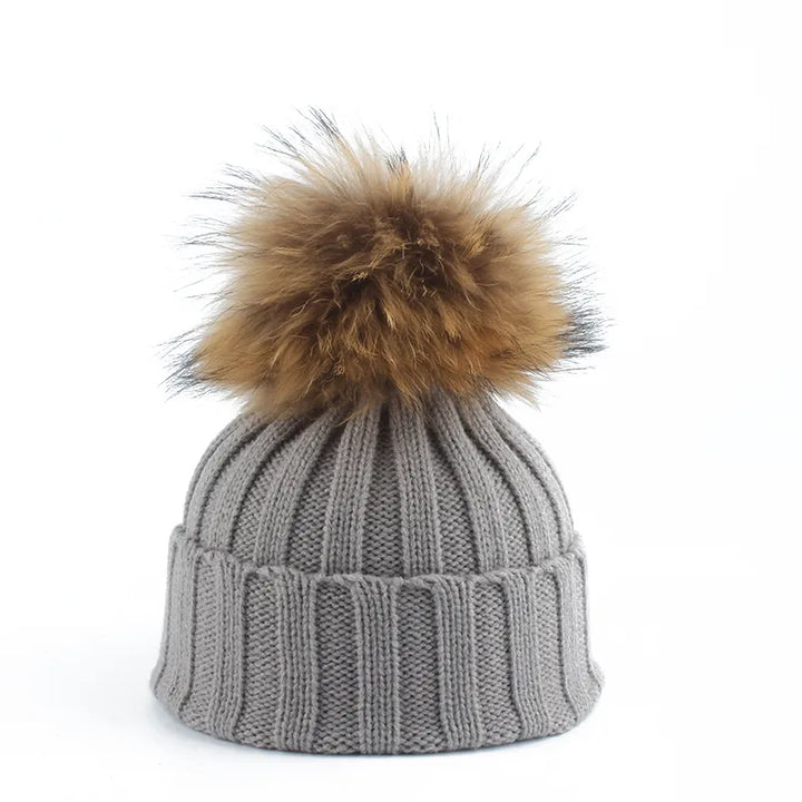 Graue Strickmütze mit braunem Kunstfellbommel, Wintermode, warme Accessoires, Unisex.
