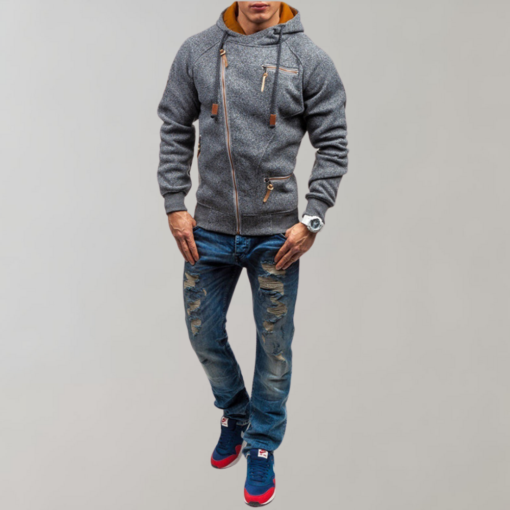 Mann in grauer Kapuzenjacke und zerrissenen Jeans, modisch, lässig, Streetwear-Look.