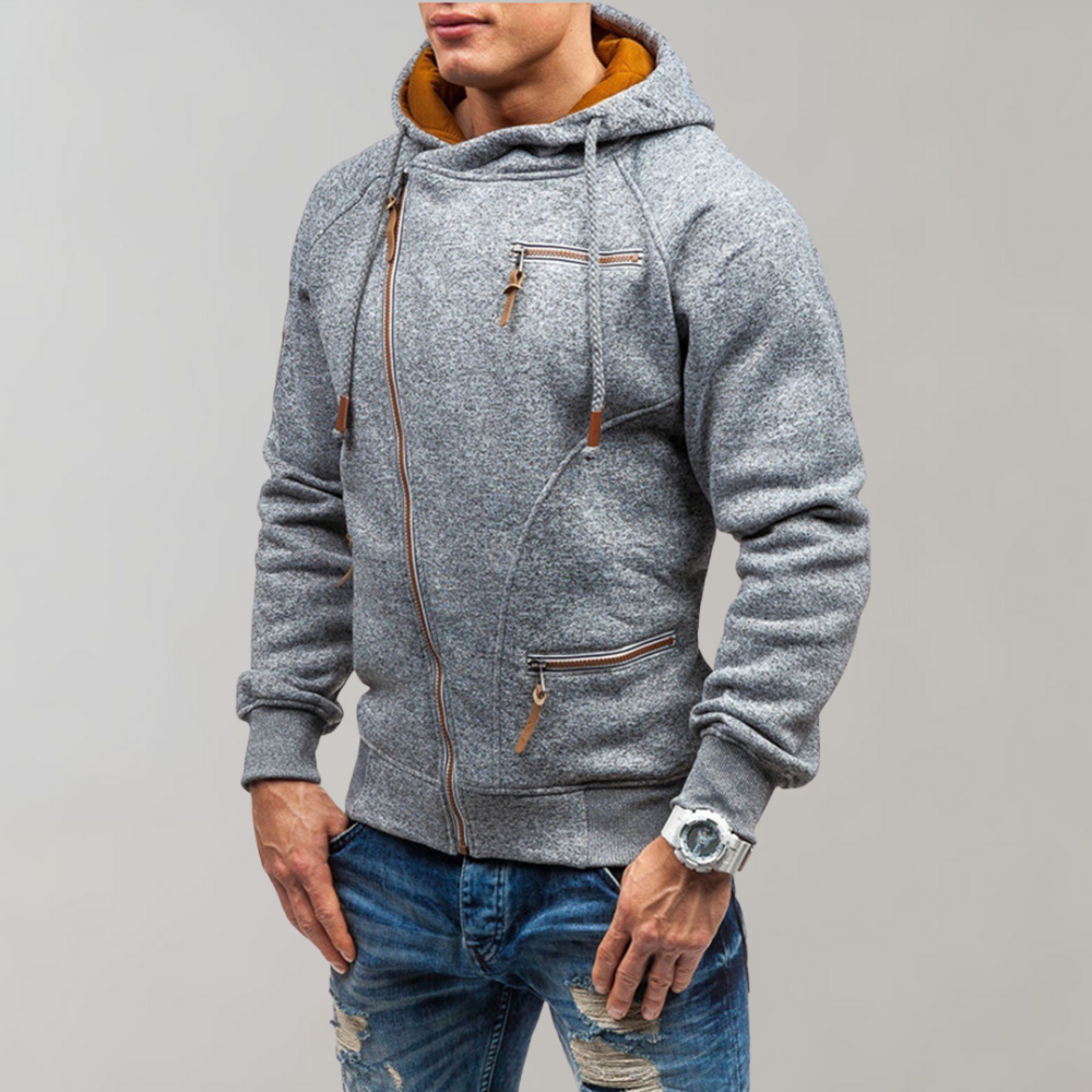 Mann in grauem Hoodie mit Reißverschlüssen, Jeans, Armbanduhr, modisch, lässiger Stil.