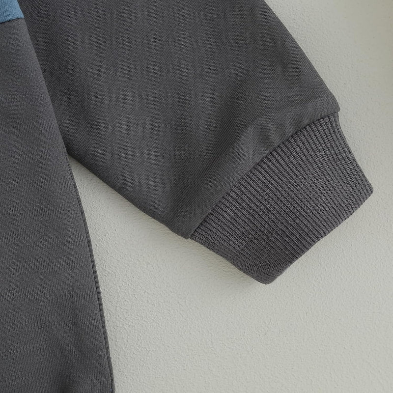 Grauer Baumwollpullover-Ärmel, gerippte Bündchen, weiches Material, modisches Design.