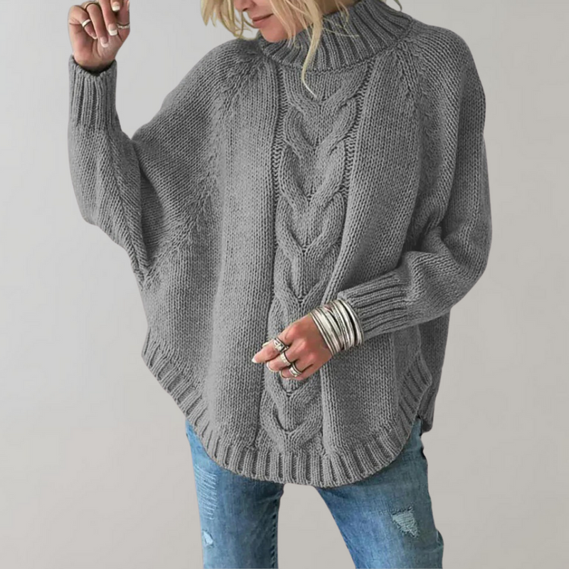 Frau in grauem Strickpullover mit Zopfmuster und Rollkragen, lässige Mode, Herbstkleidung.