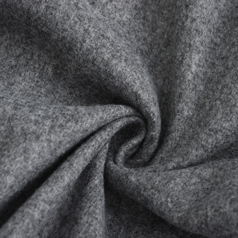 Grauer Wollstoff, weiche Textur, hochwertiges Material, ideal für Bekleidung und Heimtextilien.