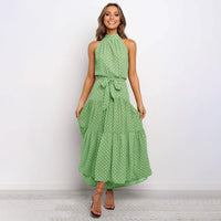 Frau in grüner gepunkteter Maxikleid, ärmellos, mit Schleife, elegantes Sommeroutfit.