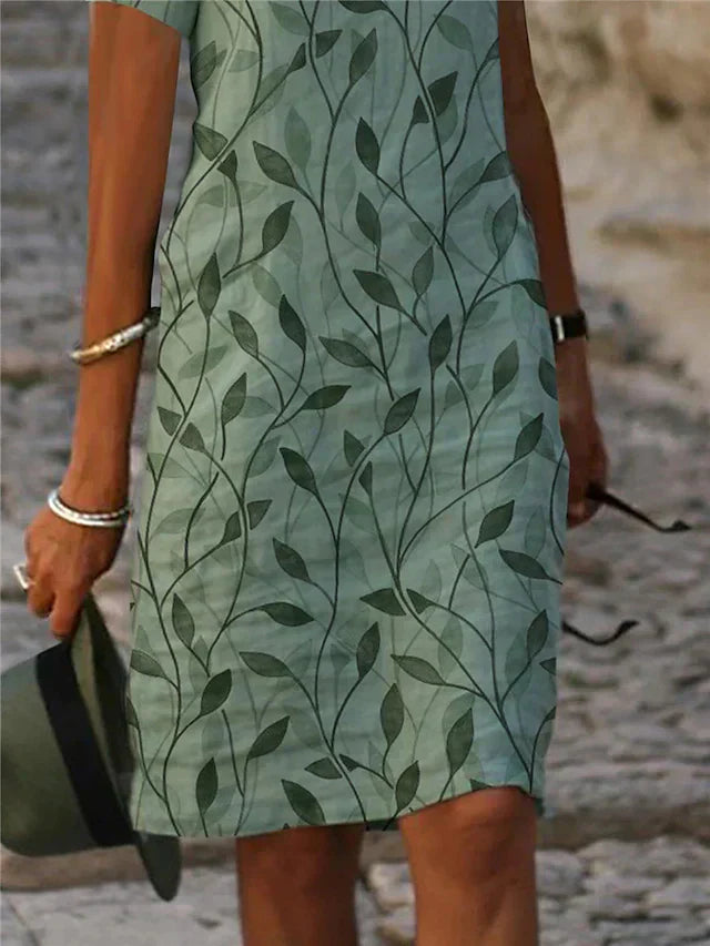 Grünes Kleid mit Blattmuster, Damenmode, Sommerkleidung, elegant, Freizeitkleid.