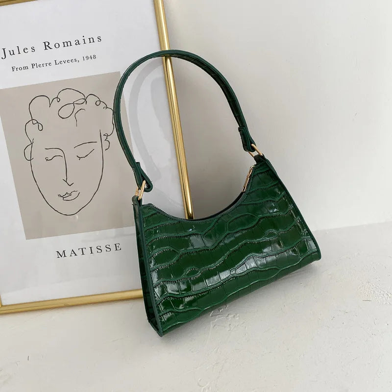 Grüne Lederhandtasche mit Krokodilprägung, elegantes Design, Damenmode-Accessoire.