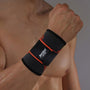 Schwarze Fitness-Handgelenkbandage mit rotem Akzent, elastisch, für Sport und Training.