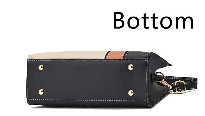 Schwarze Lederhandtasche mit goldenen Nieten, Bodenansicht, modisch, elegant, Damenaccessoire.