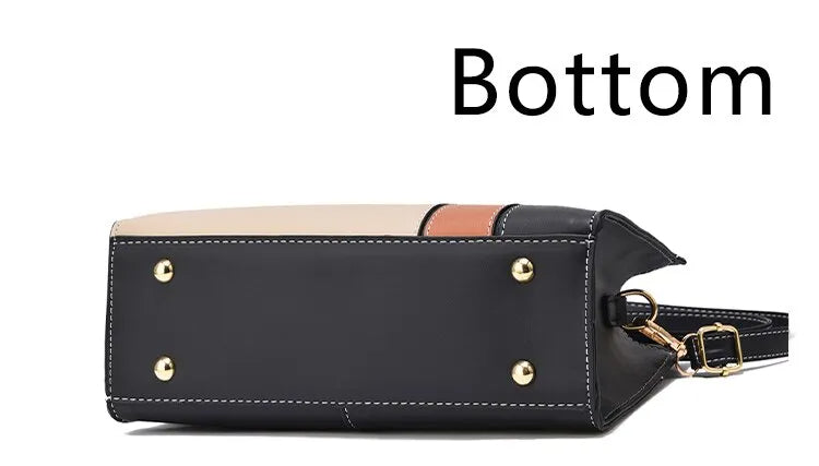 Schwarze Lederhandtasche mit goldenen Nieten, Bodenansicht, modisch, elegant, Damenaccessoire.