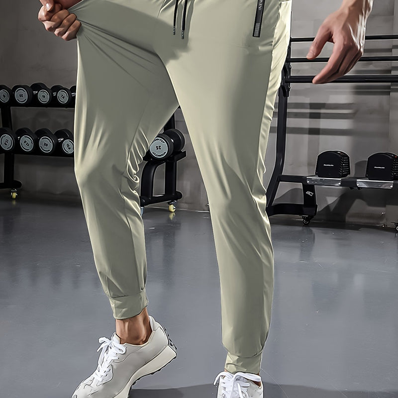 Herren Jogginghose beige, elastisch, Fitnessstudio, Sportbekleidung, bequem, modern, atmungsaktiv.