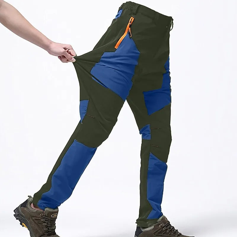 Wasserdichte Outdoor-Hose, grün-blau, mit Reißverschlusstasche, ideal für Wandern und Trekking.