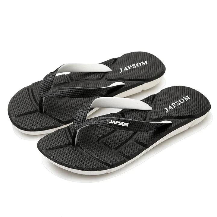 Schwarze Japsom Flip-Flops aus Gummi, rutschfest, bequem, ideal für Sommer und Strand.