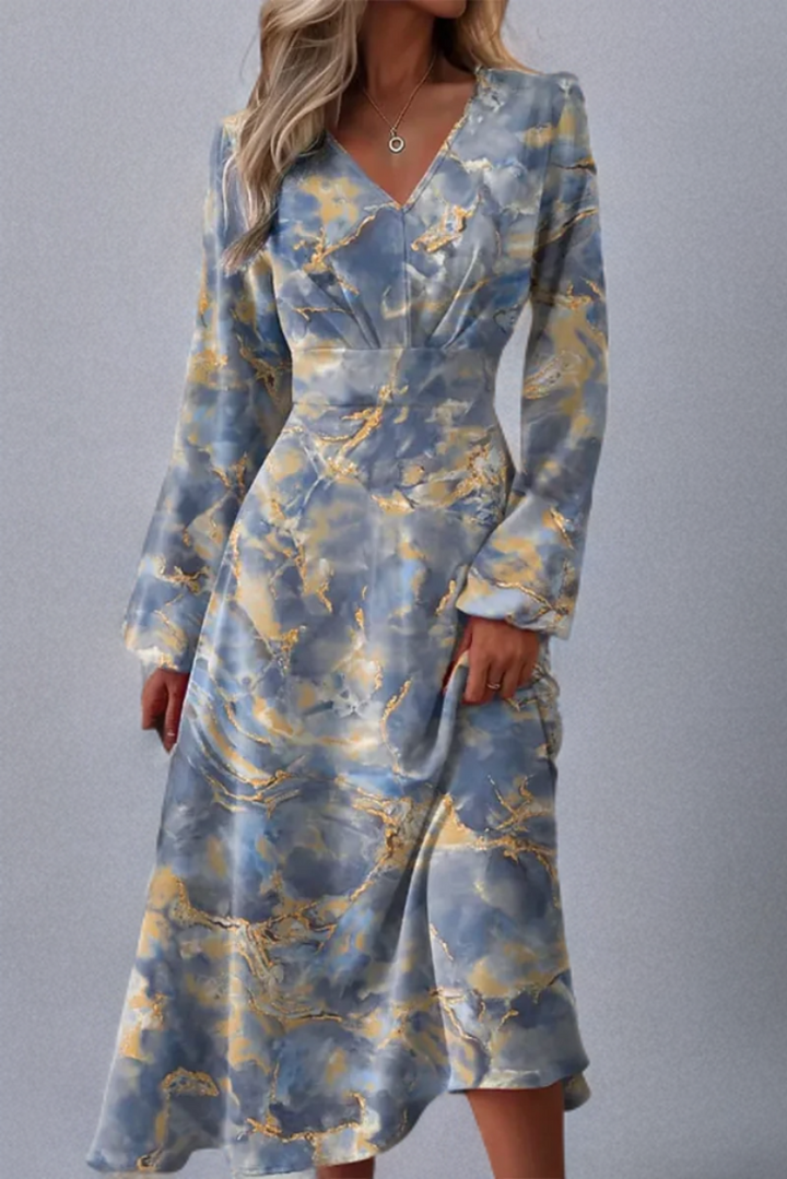 Frau in blau-gelbem, langärmligem, gemustertem Kleid, elegantes Design, modisch.