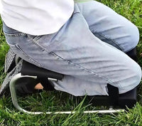 Person kniet auf tragbarem Kniekissen im Freien, Jeans, nachhaltige Konstruktion.