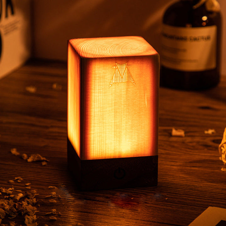 Leuchtender Holzwürfel-Lampe auf Holztisch, warmes Licht, dekorative Beleuchtung, modern.