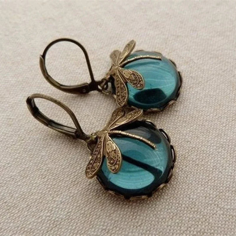 Vintage bronzene Libellen-Ohrringe mit blauem Glas, modische Damen-Accessoires.
