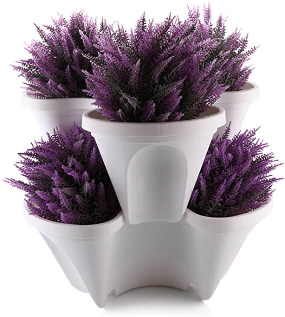Weiße, stapelbare Pflanzgefäße mit lila Kunstlavendel, dekorativer Blumentopf.