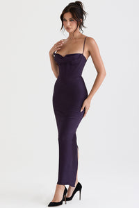 Frau in lila Satin-Abendkleid mit Spaghettiträgern und Corsage, elegante Mode, schwarze Pumps.