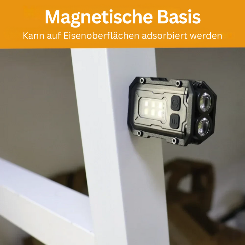 Schwarze LED-Taschenlampe mit magnetischer Basis an Metalloberfläche befestigt.