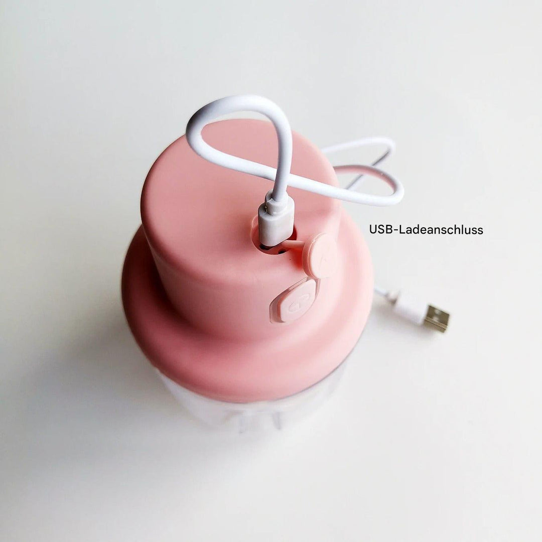 Rosa elektrischer Zerkleinerer mit USB-Ladeanschluss, kompakt, Küchenzubehör.