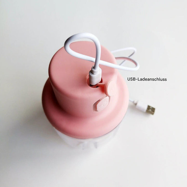 Rosa elektrischer Zerkleinerer mit USB-Ladeanschluss, kompakt, Küchenzubehör.