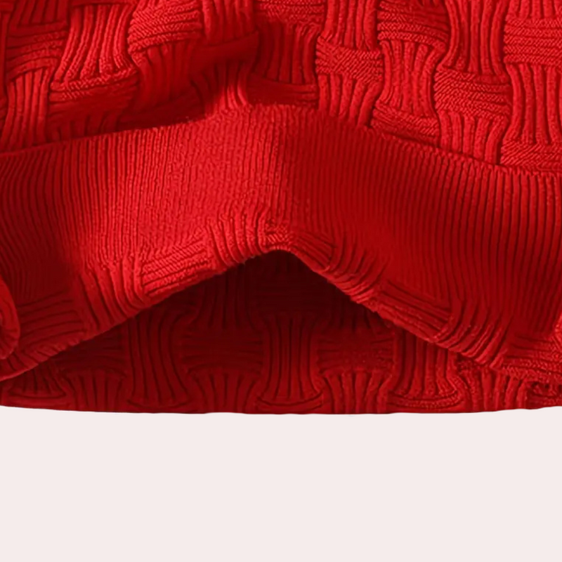 Roter Strickstoff, gewebtes Muster, Textilmaterial, Mode, Bekleidung, Detailansicht.